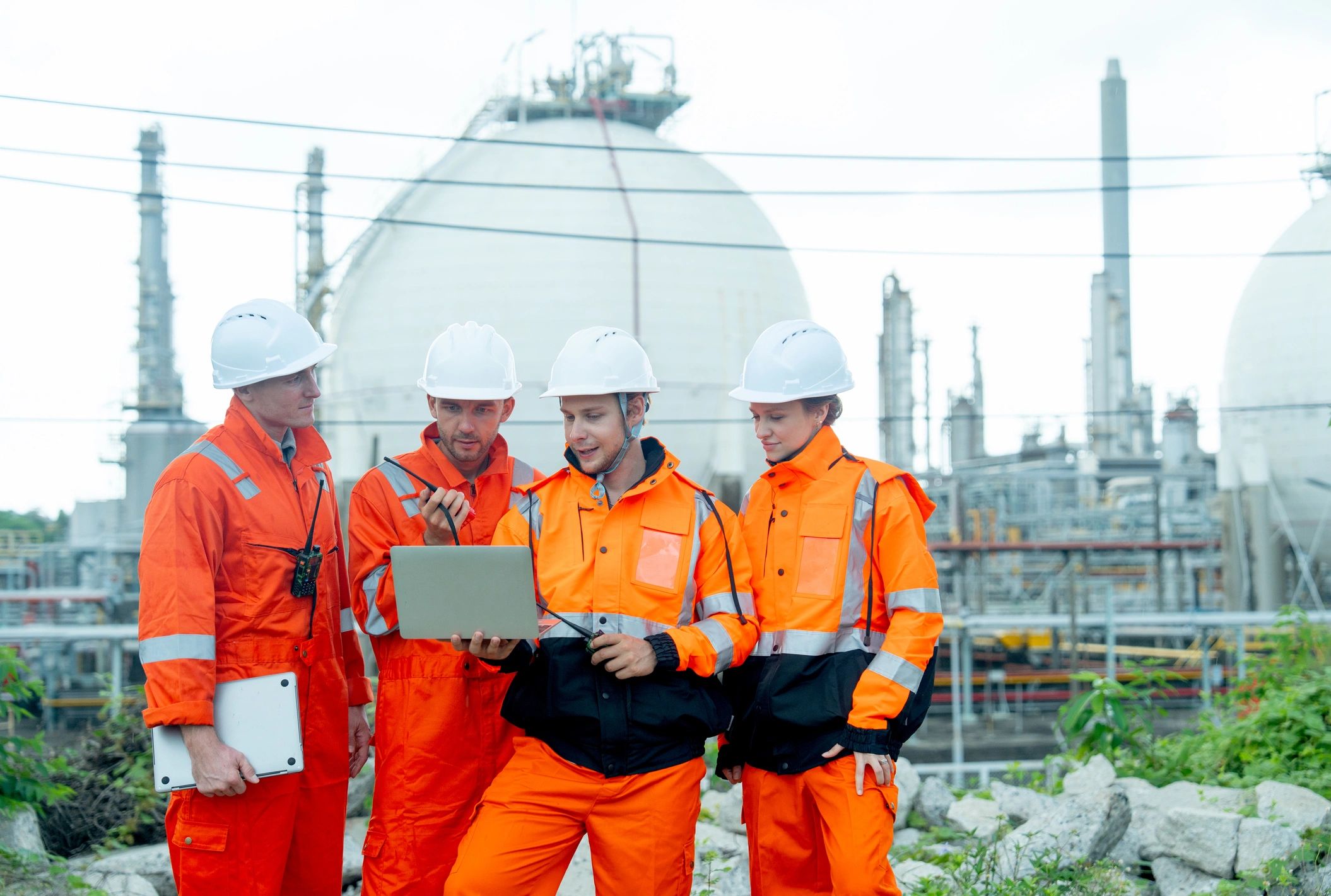 Engineering professionals discussing work at an industrial energy site