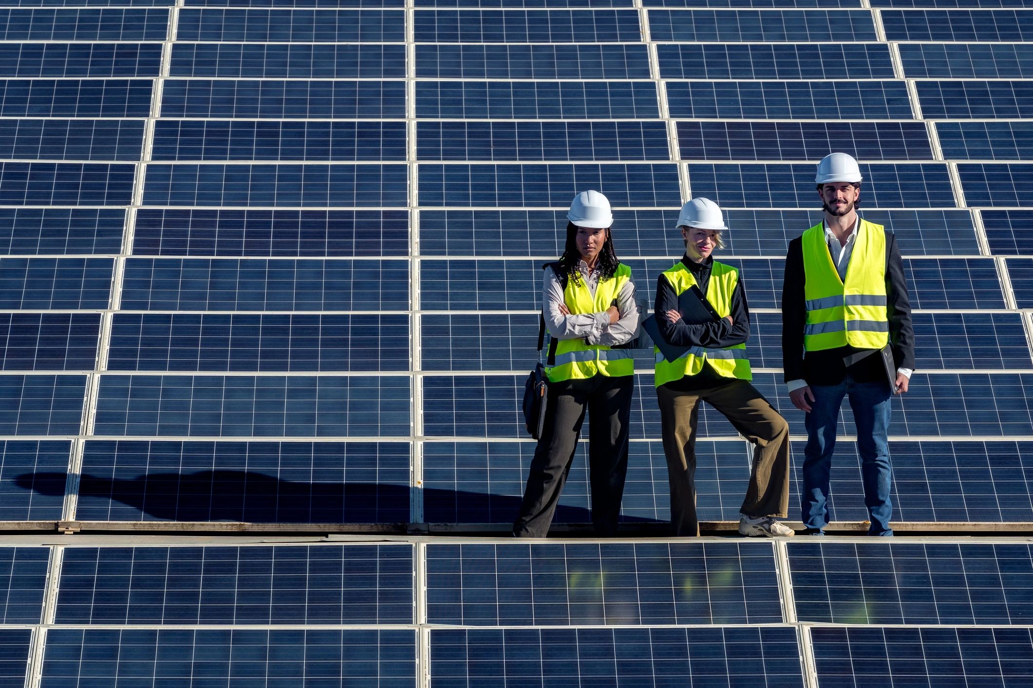 Renewable energy engineers standing on a solar installation